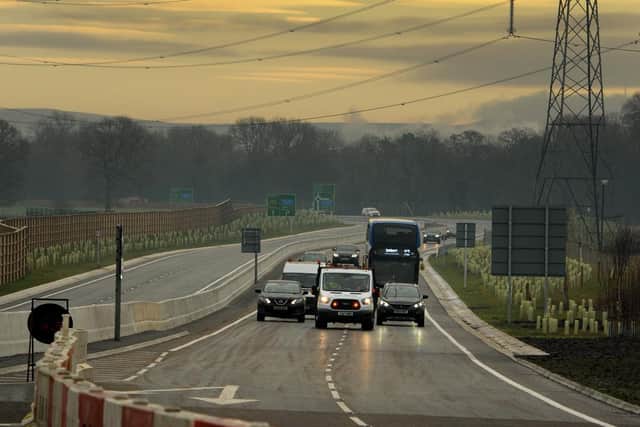 A highways van leads the first vehicles on the new Penwortham Bypass.