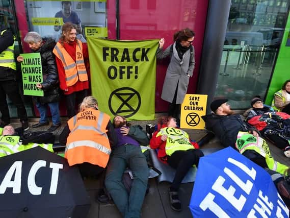 Activists from Extinction Rebellion stage an anti-fracking protest outside the Department for Business, Energy and Industrial Strategy in Westminster, London
