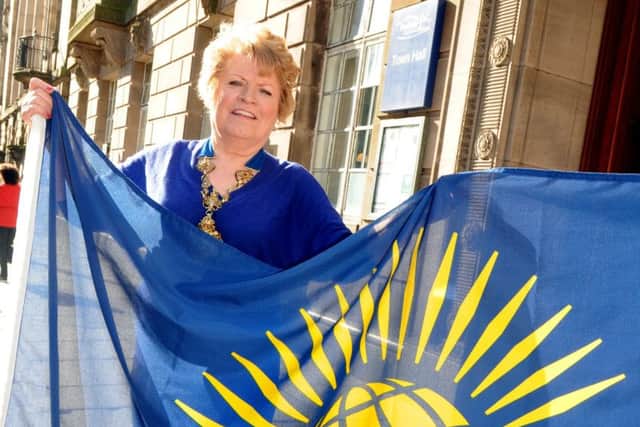 Coun Veronica Afrin while she was Mayor of Preston, with the Commonwealth flag at the Commonwealth Day celebrations in the Town Hall.