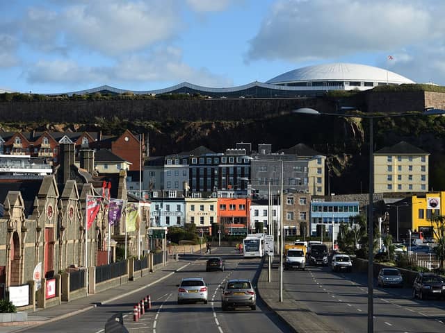 Cars travel by the seafront in St Helier, on the British island of Jersey