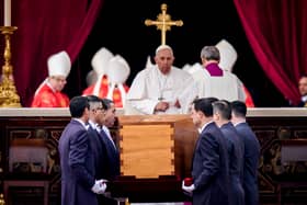 Pope Francis attends the funeral mass for Pope Emeritus Benedict XVI as pallbearers carry the coffin at the end of the funeral mass at St. Peter's square