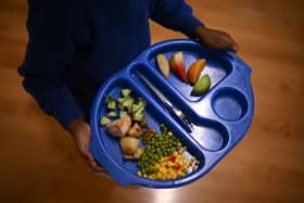 A child carries a tray with food during lunch-break at St Mary’s RC Primary School, in Battersea, south London.