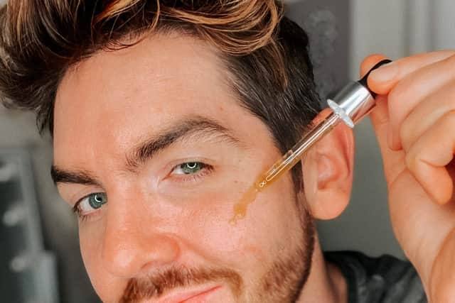 Scott McGlynn applying a serum.