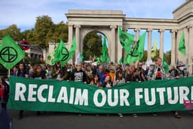 Protesters march into central London at a demonstration by the climate change protest group Extinction Rebellion, on October 16, 2022. Credit: Isabel Infantes/AFP.