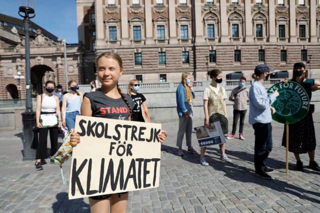 Swedish climate activist Greta Thunberg and other activists gather for a protest against climate change in front of the Swedish parliament building in Stockholm (photo: Christine Olsson/ TT News Agency/ AFP via Getty Images)