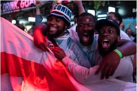 England fans cheer as they watch a live broadcast of the semi-final match between England and Denmark  (Getty Images)
