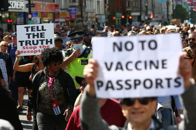 A Met Police officer walks amongst protestors during a "Unite For Freedom" anti-lockdown demonstration held to protest against the use of vaccine passports. (Photo: Hollie Adams/Getty Images)
