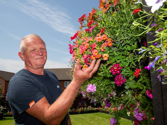 Shaun Schroeder, 59, plants around 140 hanging baskets and fence planters each year. 