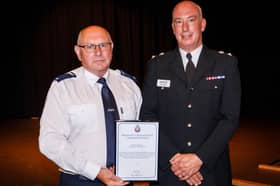 National Highways traffic officer Dereck Morrison (left) collecting his award from Chief Superintendent Mark Dexter, Head of Specialist Operations Branch at Greater Manchester Police 