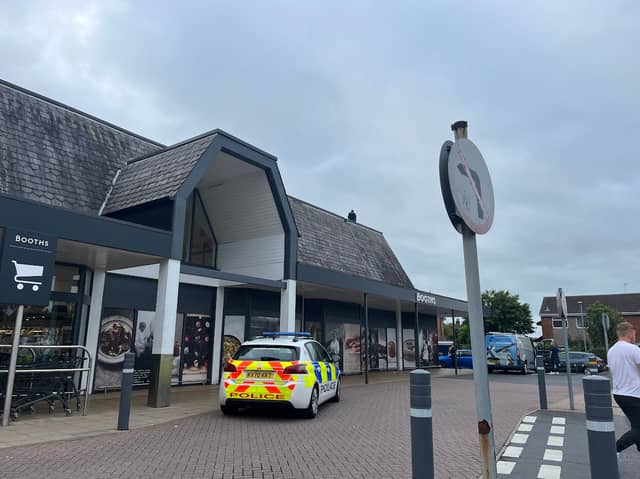 There was a huge police presence outside Booths, in Fulwood, when a man climbed onto the roof this evening