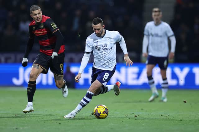 QPR striker Lyndon Dykes chases down Alan Browne during last night's Championship game at Deepdale