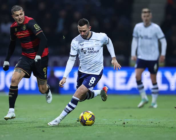 QPR striker Lyndon Dykes chases down Alan Browne during last night's Championship game at Deepdale
