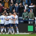 The Preston North End players congratulate Liam Millar following his winner against Leeds United