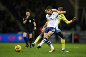 Ched Evans of Preston North End passes the ball whilst under pressure from Anthony Musaba of Sheffield Wednesday