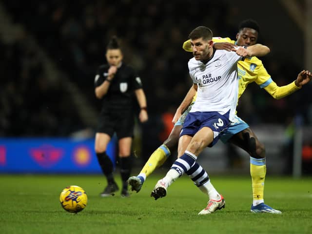 Ched Evans of Preston North End passes the ball whilst under pressure from Anthony Musaba of Sheffield Wednesday