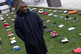 Idris Elba stands in front of an installation of over 200 bundles of clothing representing the lives lost to Knife crime in the UK as he calls on the Government to take immediate action to prevent serious youth violence at Parliament Square on January 08, 2024. (Photo by Jeff Spicer/Getty Images for Don't Stop Your Future)