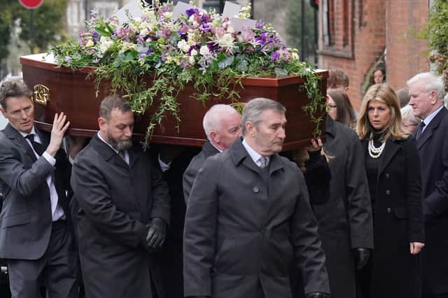 Kate Garraway follows the coffin into the funeral service of her husband Derek Draper. 