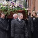 Kate Garraway follows the coffin into the funeral service of her husband Derek Draper. 