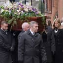 Kate Garraway follows the coffin into the funeral service of her husband Derek Draper. 