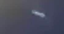 In the video - at 23 seconds - a white object is seen darting through the sky at incredible speed. Blink and you'll miss it, but you can examine it more closely in this zoomed in still shot. What is it?