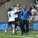 Simon Grayson celebrates with Jermaine Beckford after the striker's goal against Swindon in the 2015 League One play-off final 