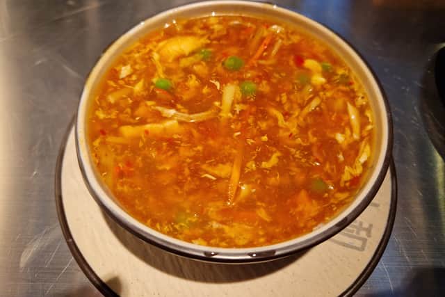 Publi's Hot and Sour Soup containing chicken, pork, prawn, peas and carrots.