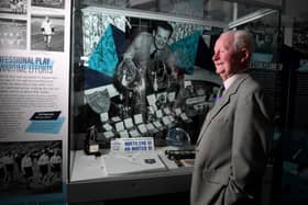Brian Finney with exhibits about his father Sir Tom at the Pride of the Pitch Exhibition launch at Lancashire Archives, Preston