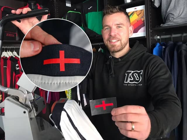 Director Grant Walters at The Sports Shop in Kingswinford show off their St George's Cross transfer to apply to new England kit. A sports shop is selling St George’s Cross iron-on transfers for £4.95 - so fans can cover the controversial design on the new England football shirt. 