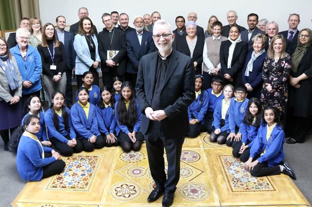 Bishop of Burnley, Rev. Dr Joe Kennedy, surrounded by many of those who attended the Burnley Faith Centre announcement on Friday.