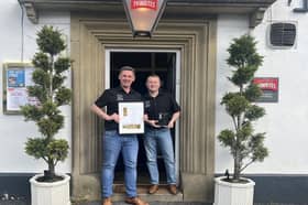 Stephen and Tom celebrating with their award outside The White Hart.