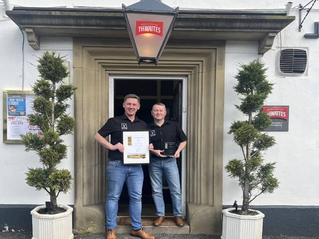 Stephen and Tom celebrating with their award outside The White Hart.