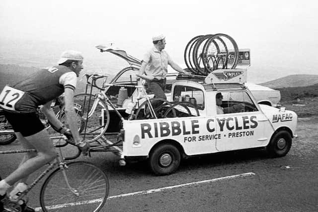 Team England's Phil Griffiths riding alongside the Ribble service vehicle.