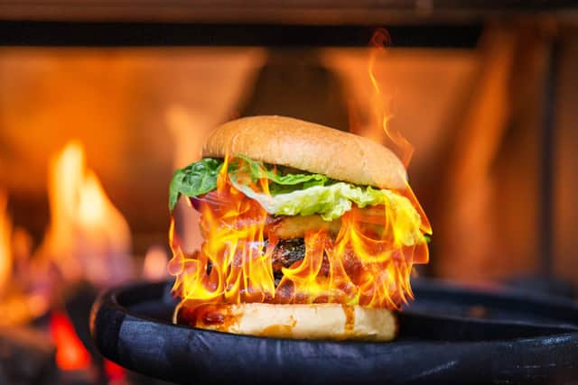 A flaming burger is part of the new dining experience
