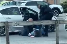 In the video, the officer was filmed dragging the driver out of a Ford Focus and wrestling him to the floor before stamping on his back as another officer applied handcuffs. He was then filmed swinging a kick at the man's head and repeatedly slapping the suspect who was detained on the ground.