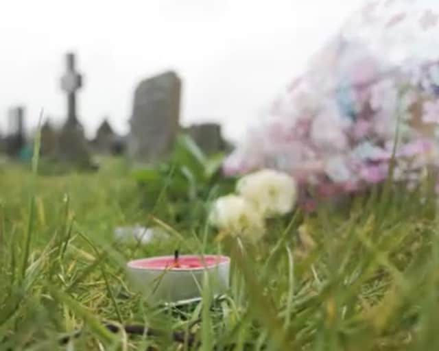 Candles and flowers are left on unmarked graves. Still from Murdered By The Seaside, a Shots! TV Documentary