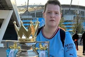 Jack, holding the Premier League trophy won by his club Manchester City.