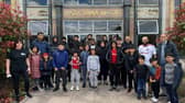 A group of children and volunteers gathered outside Raza Jamia Masjid ahead of their walk from the mosque to an Accrington Stanley match.