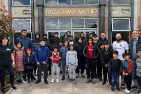 A group of children and volunteers gathered outside Raza Jamia Masjid ahead of their walk from the mosque to an Accrington Stanley match.