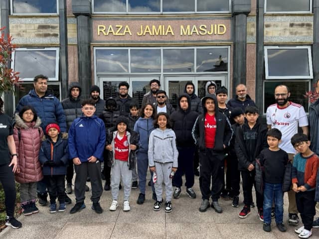 A group of children and volunteers gathered outside Raza Jamia Masjid ahead of their walk from the mosque to an Accrington Stanley match.