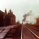 A cold winter's afternoon in the mid-1950s as the banking engine of a long freight works hard up Whalley Bank after passing through Langho station. Ken Roberts from Freight Trains in the North of England by John Matthews