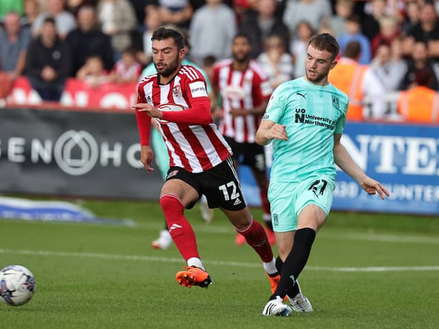 Reece Cole (L) was playing non-league football until the summer of 2023. The Exeter City midfielder now has three EFL clubs interested in him. (Photo by Pete Norton/Getty Images)