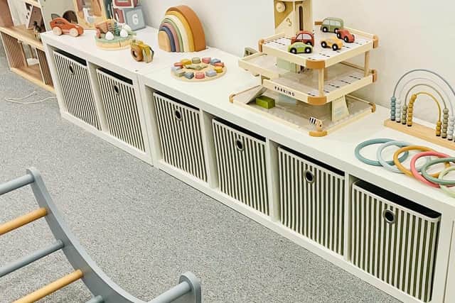 The tastefully decorated play centre has handcrafted, wooden toys including a play kitchen and workbench with tools, dolls house and lots of other educational toys and games.