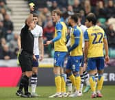 Stoke City's Wouter Burger is shown a yellow card 