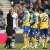 Stoke City's Wouter Burger is shown a yellow card 