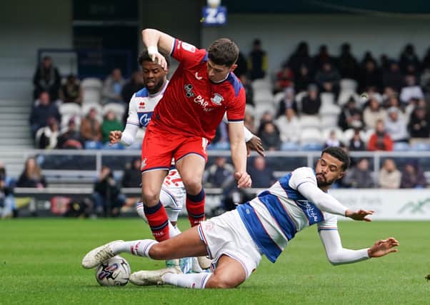 Preston North End's Jordan Storey is tackled by Queens Park Rangers' Jake Clarke-Salter