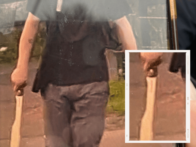 A chilling image of man walking the streets of Preston armed with a machete just moments after a stabbing