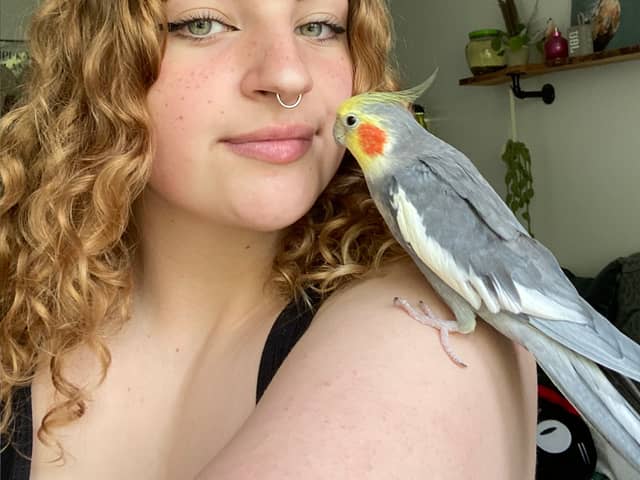 Grace Robinson, 19, with her pet cockatiel Kiki.