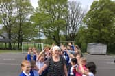Welfare assistant at St Laurence CE Primary School, pictured with children, retired from her role after last Friday.