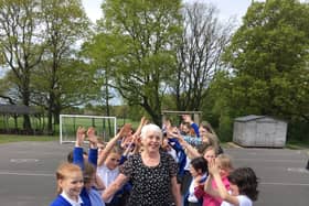Welfare assistant at St Laurence CE Primary School, pictured with children, retired from her role after last Friday.