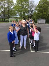 Welfare assistant at St Laurence CE Primary School, pictured with children, retired from her role after last Friday.